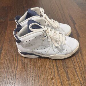 These are Nike Air Jordan 13c Retro sneakers in a white and "Midnight